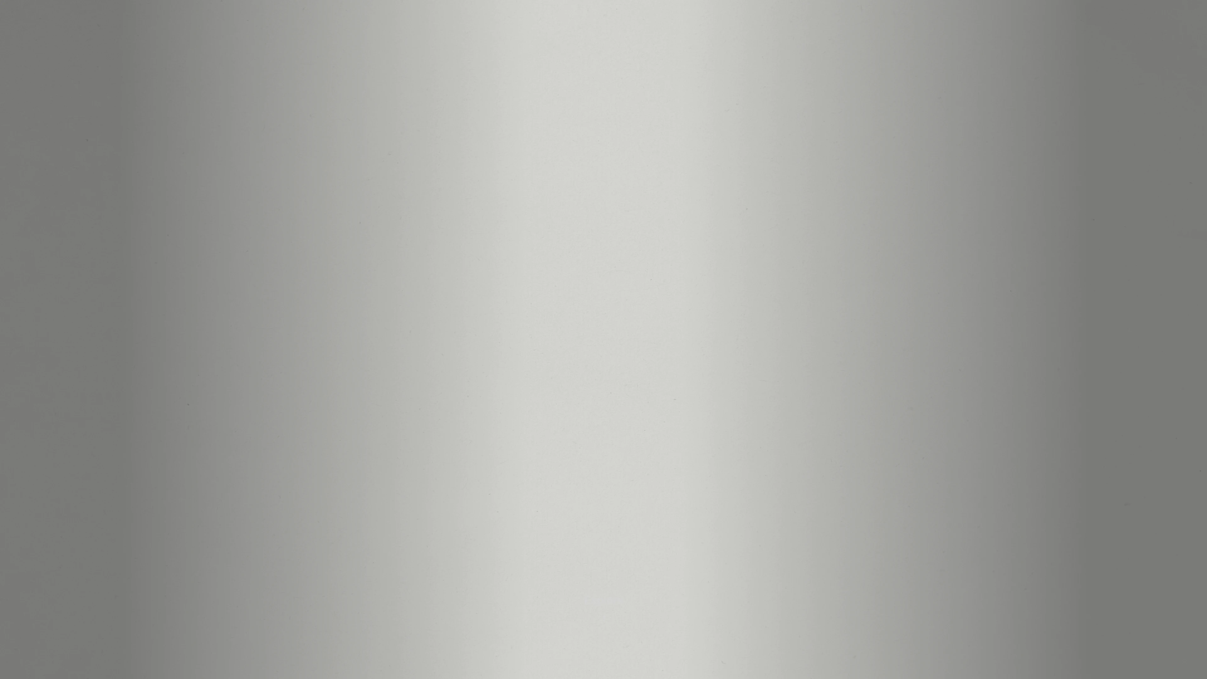 A smooth, uniform gradient transitioning from light gray in the center to darker gray at the edges, creating a subtle metallic appearance.